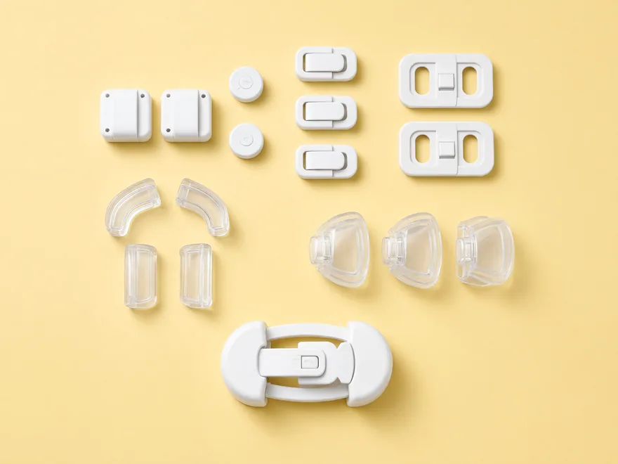 Crawler kit laid out: magnetic cabinet locks, drawer latches, outlet covers, corner guards, knob covers and a toilet lock
