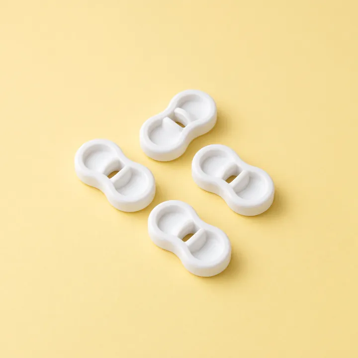 Four white figure-eight blind cord wind-ups