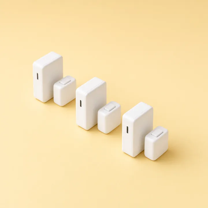 Four white door and window alarm sensors with their magnets