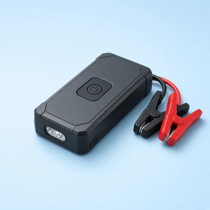 Compact graphite jump starter with red and black battery clamps