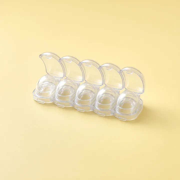Five clear stove knob covers in a row