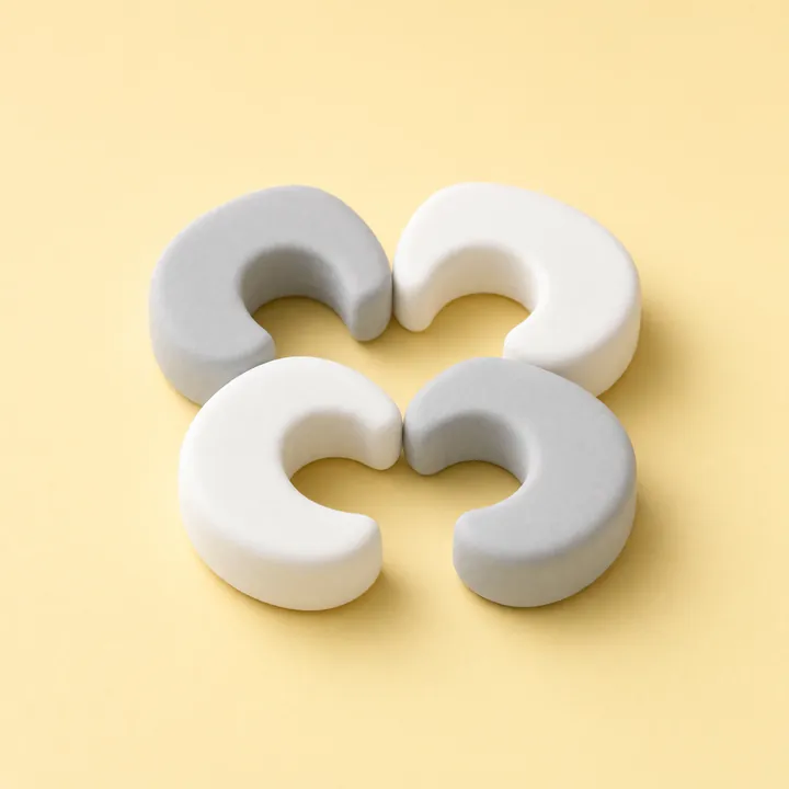 Four C-shaped gray and white foam door pinch guards