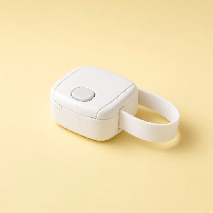 White toilet lid lock with a strap and a round release button