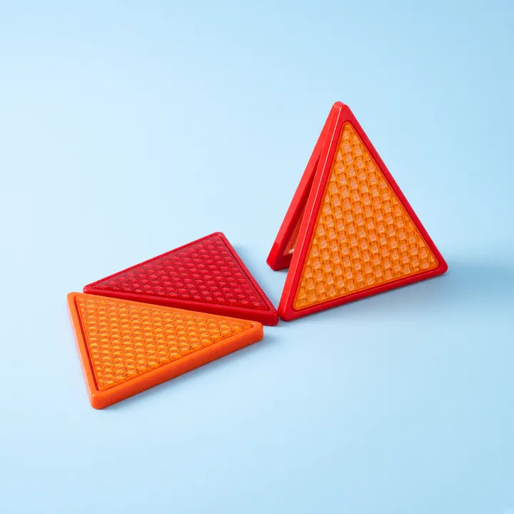 Red and orange reflective warning triangles, one standing upright